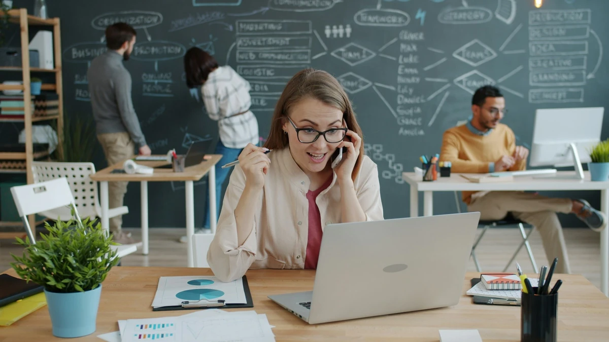 woman celebrating success while on a business call